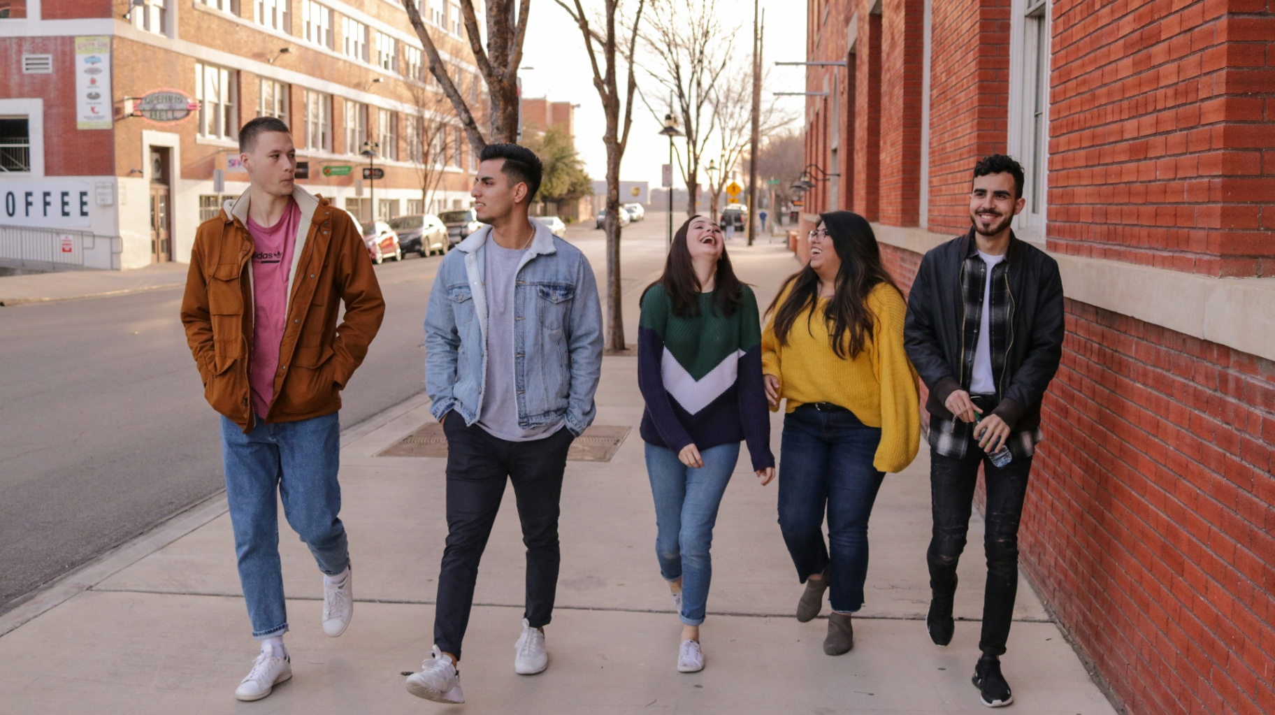 Young adults walking together, close friends in conversation